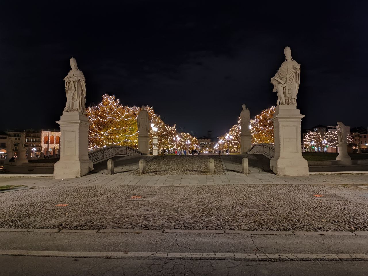 The photo shows Prato della Valle in the evening, one of the most important landmarks in Padua, decorated with Christmas lights in December. The photo shows Prato della Valle in the evening, one of the most important landmarks in Padua, decorated with Christmas lights in December.